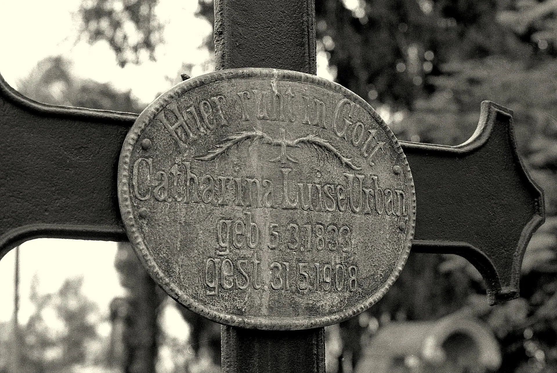 Cruz de ferro de túmulo com placa oval de metal, com inscrição em alemão, em fotografia em preto e branco